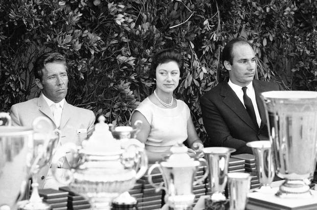 From left, Princess Margaret of Britain, Lord Snowdon and Prince Karim Aga Khan watch a yachting regatta on the Emerald Coast of Sardinia, Italy on Aug. 14, 1966.
