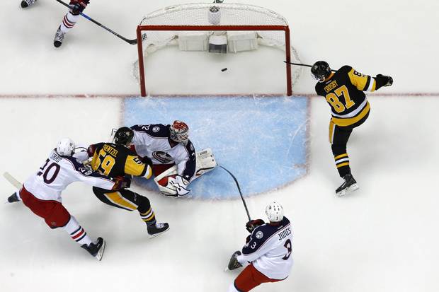 Pittsburgh Penguins' Sidney Crosby (87) shoots the puck behind Columbus Blue Jackets goalie Sergei Bobrovsky (72) for a goal during the first period in Game 2 of an NHL first-round hockey playoff series in Pittsburgh, Friday, April 14, 2017.