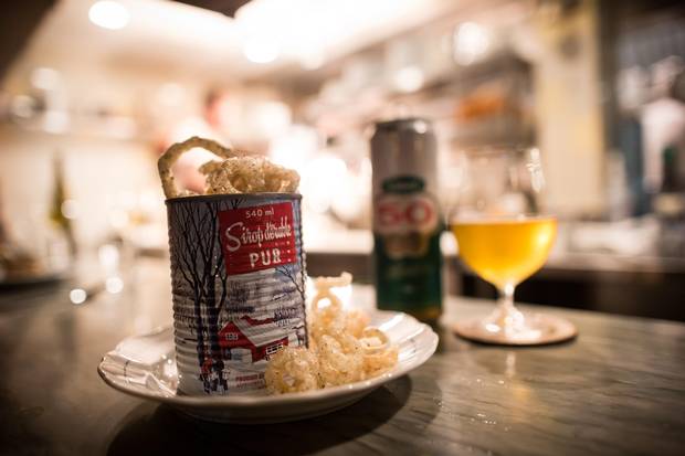 Deep-fried pork rinds are served tossed in maple syrup and Montreal steak spice and come flowing over the lip of a maple-syrup tin can at St. Lawrence.