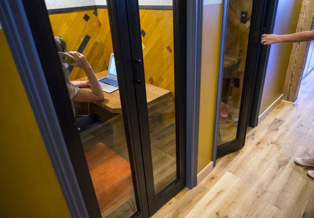In addition to phone booths for private conversations and work, WeWork’s Richmond Street West facility has other amenities such as a front desk to announce visitors.