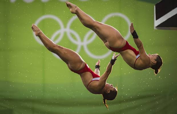Canadian divers Meaghan Benfeito and Roseline Filion compete in the women's 10 meter synchronized 10m platform final at Rio Olympics August 9, 2016.