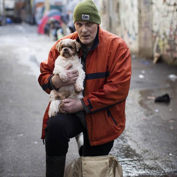 Robert Dumas and his dog Chico are photographed in Vancouver's Downtown Eastside, British Columbia, Friday, December 22, 2017.
