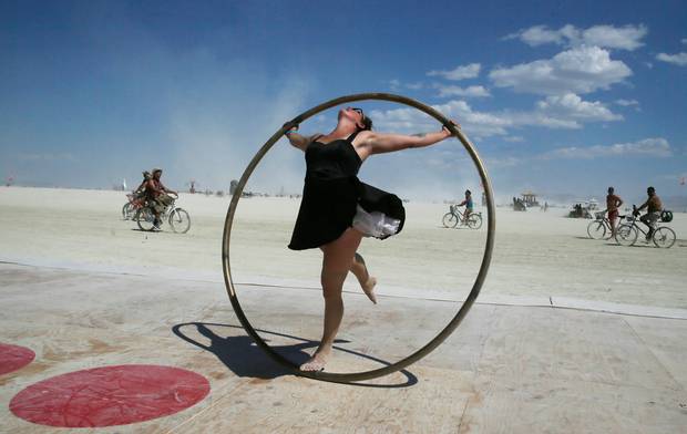 Kylie Webb spins inside a metal hoop on a roller disco floor, Aug. 28, 2017.