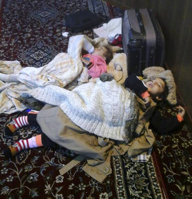 Karima, 5, and Ayat, 1, children of Iwan and Zamzam Dalaa, sleep in the airport mosque after not being allowed to board a commercial flight that would take them to Canada. The family was one of several Syrian refugees left stranded in Beirut after being denied boarding.