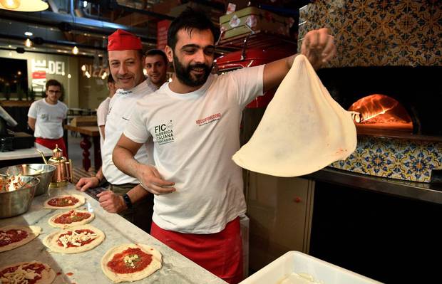 Pizza bakers prepare traditional pizza margherita r at in FICO Eataly World agri-food park in Bologna in November, 2017.