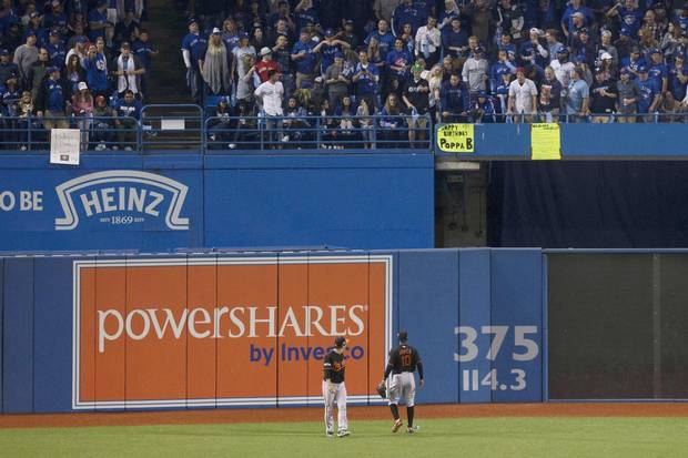Baltimore Orioles' Hyun Soo Kim, left, and Adam Jones yell at members of the crowd after a beer can was thrown at Kim during play during seventh inning American League wild-card game action in Toronto on Tuesday, October 4, 2016.