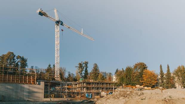 A crane works on a project under construction by the Co-op Federation along the Fraser River.