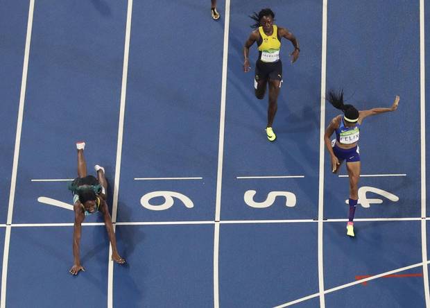 Bahamas' Shaunae Miller dives across the finish line ahead of United States' Allyson Felix to win the gold medal in the 400 meter finals during the athletics competitions of the 2016 Summer Olympics at the Olympic stadium in Rio de Janeiro, Brazil, Monday, Aug. 15, 2016.