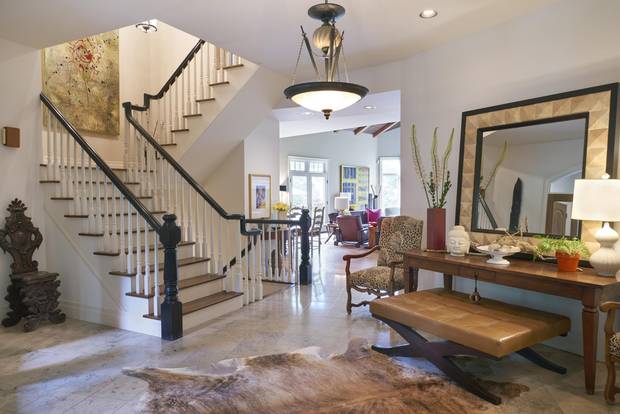 The entrance leads to a large foyer with a winding staircase and formal living room.