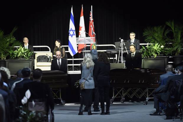 Dec. 21: The caskets arrive during a memorial service for the Shermans in Mississauga.