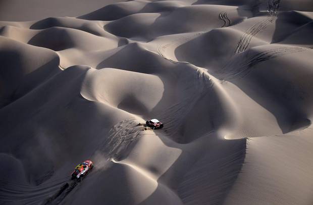 Ford's Czech driver Martin Prokop and co-driver Jan Tomanek (L) and Mini's Finnish driver Mikko Hirvonen and German co-driver Andreas Schulz ride through the dunes of Tanaca during the 2018 Dakar Rally Stage 5 between San Juan De Marcona and Arequipa in Peru. Sebastien Loeb was forced to pull out of the Dakar Rally after a back injury suffered by his co-driver in a disastrous fifth stage won by defending champion Stephane Peterhansel. The rally is scheduled to wrap up on Jan. 21
