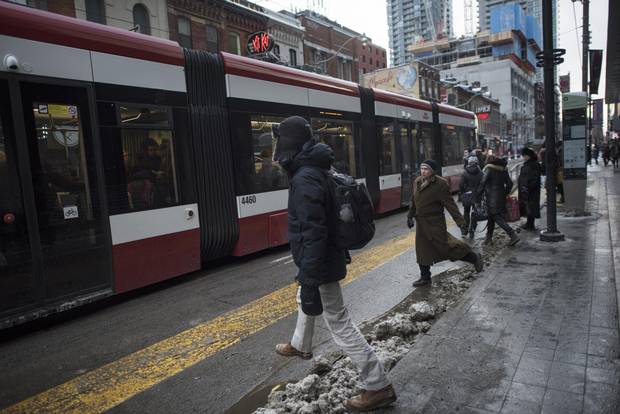 Passengers prepare to board a westbound streetcar on King St. West near John St., on Feb 8 2018.
