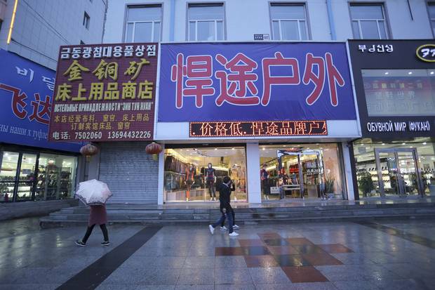 Korean-, Chinese- and Russian-language signs hang above the stores in Hunchun, a Chinese city sandwiched between North Korea and Russia.