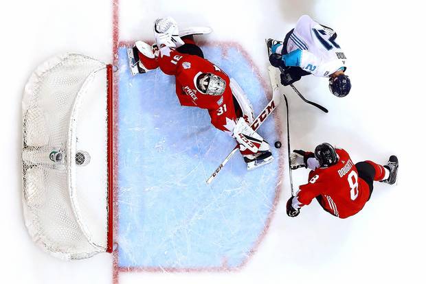 Carey Price and Drew Doughty of Team Canada defend against Tomas Tatar of Team Europe during the second period of Game 1.