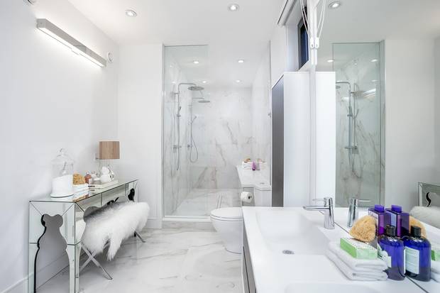 The master suite's bathroom features a walk-in shower with a built-in bench.