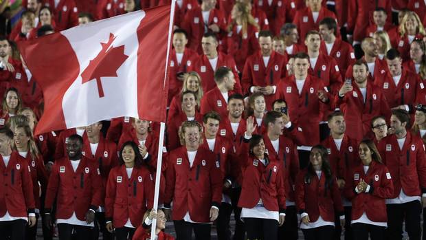 Rosie MacLennan carries the flag of Canada during the opening ceremony for the 2016 Summer Olympics in Rio de Janeiro, Brazil, Friday, Aug. 5, 2016.