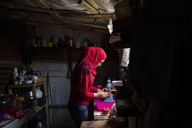 Syrian teenager Basima prepares food in a makeshift shelter in Zahle, Lebanon in May, 2015. Refugees receive about $20 U.S. per person per month from the World Food Programme
