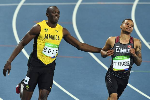 TOPSHOT - Jamaica's Usain Bolt (L) smiles next to Canada's Andre De Grasse after they competed in the Men's 100m Semifinal during the athletics event at the Rio 2016 Olympic Games at the Olympic Stadium in Rio de Janeiro on August 14, 2016. / AFP PHOTO / Jewel SAMADJEWEL SAMAD/AFP/Getty Images