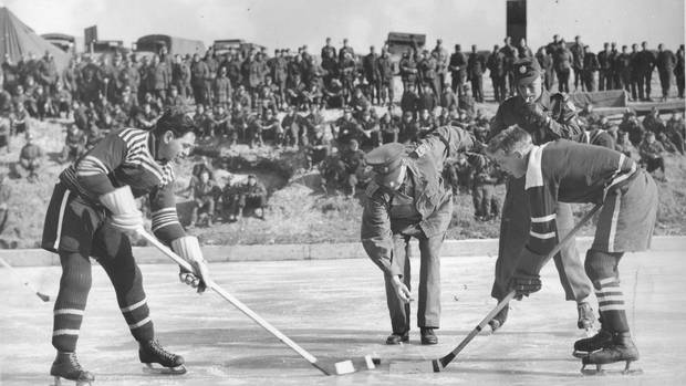Players face off during a hockey game on the Imjin River in Korea, in January, 1952.