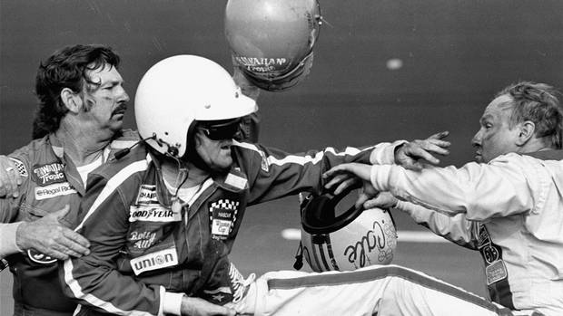 5 FILE - In this Feb. 18, 1979, file photo, Bobby Allison holds race driver Cale Yarborough's foot after Yarborough, right, kicked him following an argument when Yarborough stopped his car during the final lap of the Daytona 500, in Daytona Beach, Fla. The brawl in the closing moments of the first race to be broadcast live in its entirety was a monumental moment for NASCAR, and the lasting image as the traditionally Southern sport officially announced its arrival on the national scene. (AP Photo/Ric Feld, File)