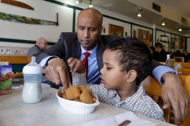 Mr. Hussen helps his middle son Maahir, 3, with his lunch at a fish-and-chips restaurant.