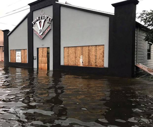 Daytona Beach, Fla., Sept. 11: A boarded-up motorcycle shop stands in flood waters.