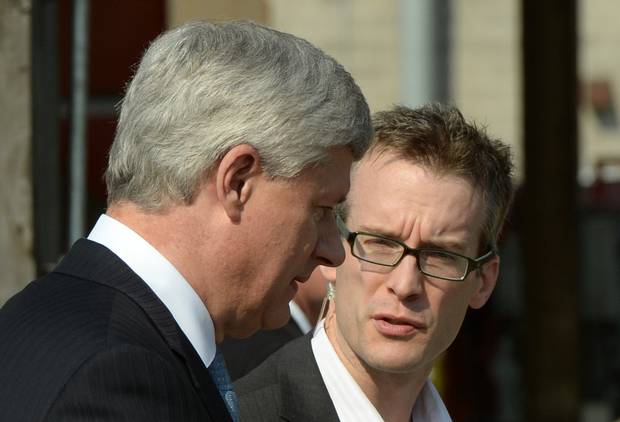 Conservative Leader Stephen Harper talks to his chief of staff, Ray Novak, in North Vancouver on Aug. 12.
