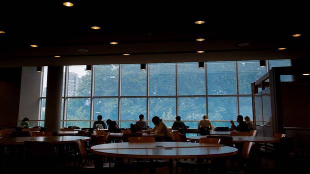 Students are silhouetted in the Irving K. Barber Learning Centre on the University of British Columbia campus in Vancouver, B.C., on Thursday August 20, 2015.