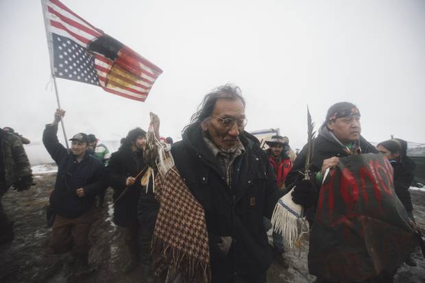Elders lead people out of the DAPL resistance camps near Cannon Ball, North Dakota in a ceremonial retreat ahead of a police enforced eviction February 22. 