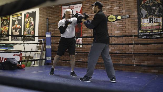 Peter Leveille, left, spars with head trainer Jorge Ravanal during a boxing program for Parkinson patients at Avenue Boxing Club, in Edmonton Alberta, December 14, 2016. Jason Franson/The Globe and Mail.