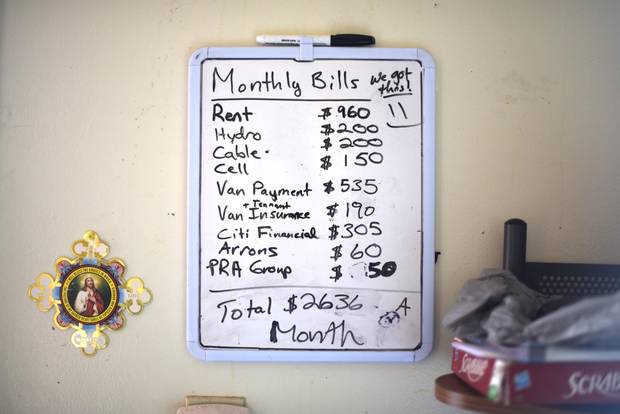 A board with the family's monthly expenses are posted on the wall at John and Brandy Childforever's Thunder Bay, Ont. home.