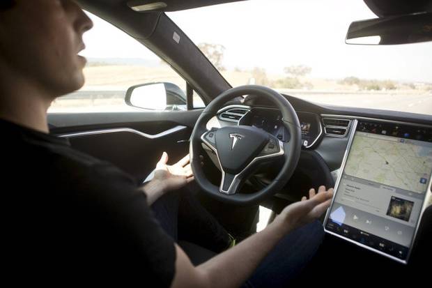 New Autopilot features are demonstrated in a Tesla Model S during a Tesla event in Palo Alto, Calif., on Oct. 14, 2015.