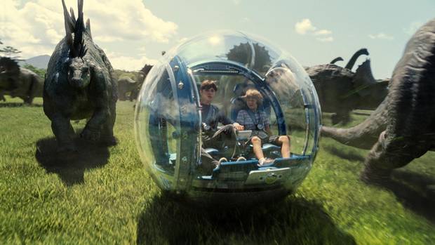 Zach (Nick Robinson) and Gray (Ty Simpkins) roam among the dinosaurs in a scene from Jurassic World.