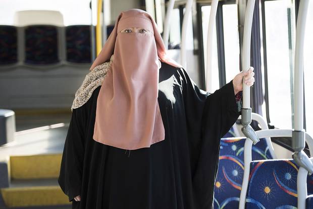 Warda Naili wears a niqab a city bus in Montreal on Oct. 21, 2017. Ms. Naili says the first time she donned a niqab six years ago, it became a part of her. The Quebec woman, a convert to Islam, said she decided to cover her face out of a desire to practice her faith more authentically and to protect her modesty.