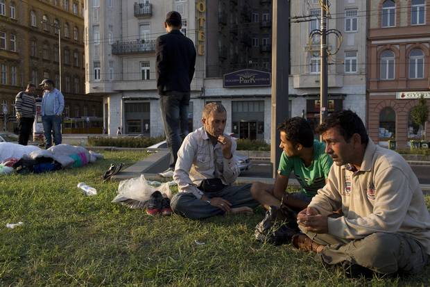 Refugees from Afghanistan wait early in the morning outside the Keleti train station.