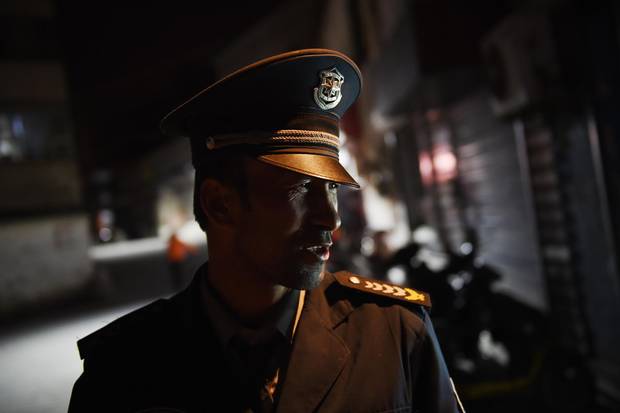 This April 17, 2015 photo shows a security guard in a Uyghur neighborhood in Aksu, in China's Xinjiang region.