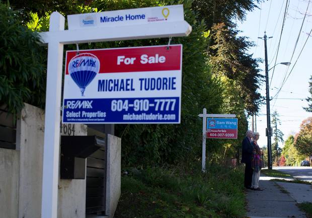 For-sale signs are seen outside houses for sale in Point Grey.