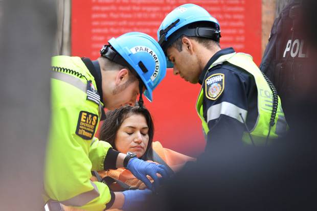 Paramedics attend to the woman after her rescue.