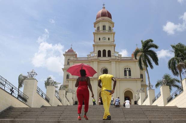 Visitors climb the stairs to the El Cobre church where the Pope attended mass on his visit to Cuba.