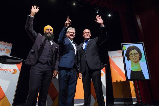 Jagmeet Singh, Charlie Angus and Guy Caron pose for a photograph as Niki Ashton appears via satellite from Ottawa before the final federal NDP leadership debate in Vancouver on Sept. 10, 2017.