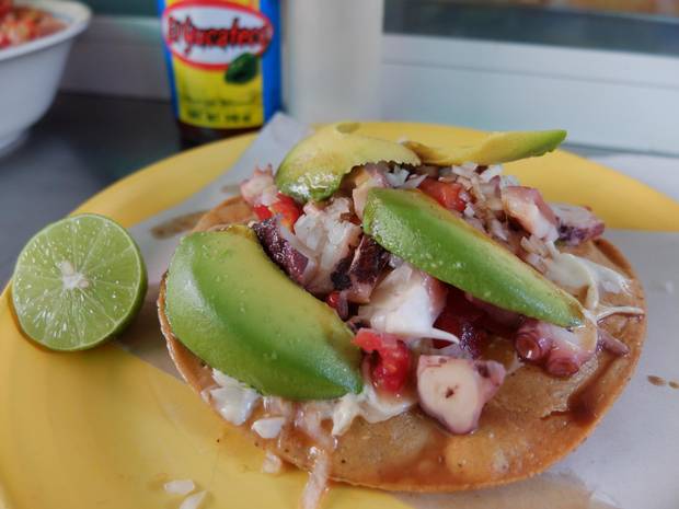 Tostadas de pulpo, fried corn tortillas topped with marinated octopus, fresh salsa and avocado, are a common sight in Mexico City.