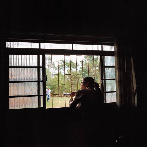 Psychologist Elizeti Moreira looks out the window of the health centre on the Dourados reservation.