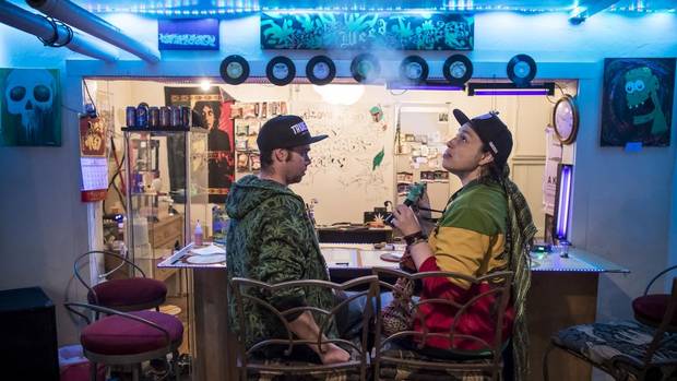 Nathan Adams, left, vice-president of the Calgary Cannabis Society and his wife, Lisa Kirkman, the president of the group, sit at the bar and share a smoke during 4/20 events in Calgary.