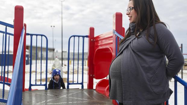 Kimberley Howcroft at the park with her son, not pictured, in Fort McMurray, Alberta on Wednesday, February 15, 2016. Ms. Howcroft says her and her husband decided to have another baby after escaping from the fire refocused their priorities on their family.