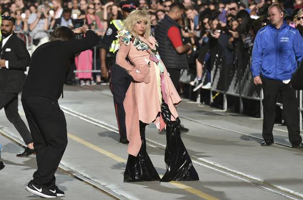 Lady Gaga poses for photographers as she arrives at a premiere for Gaga: Five Foot Two at the Princess of Wales Theatre.