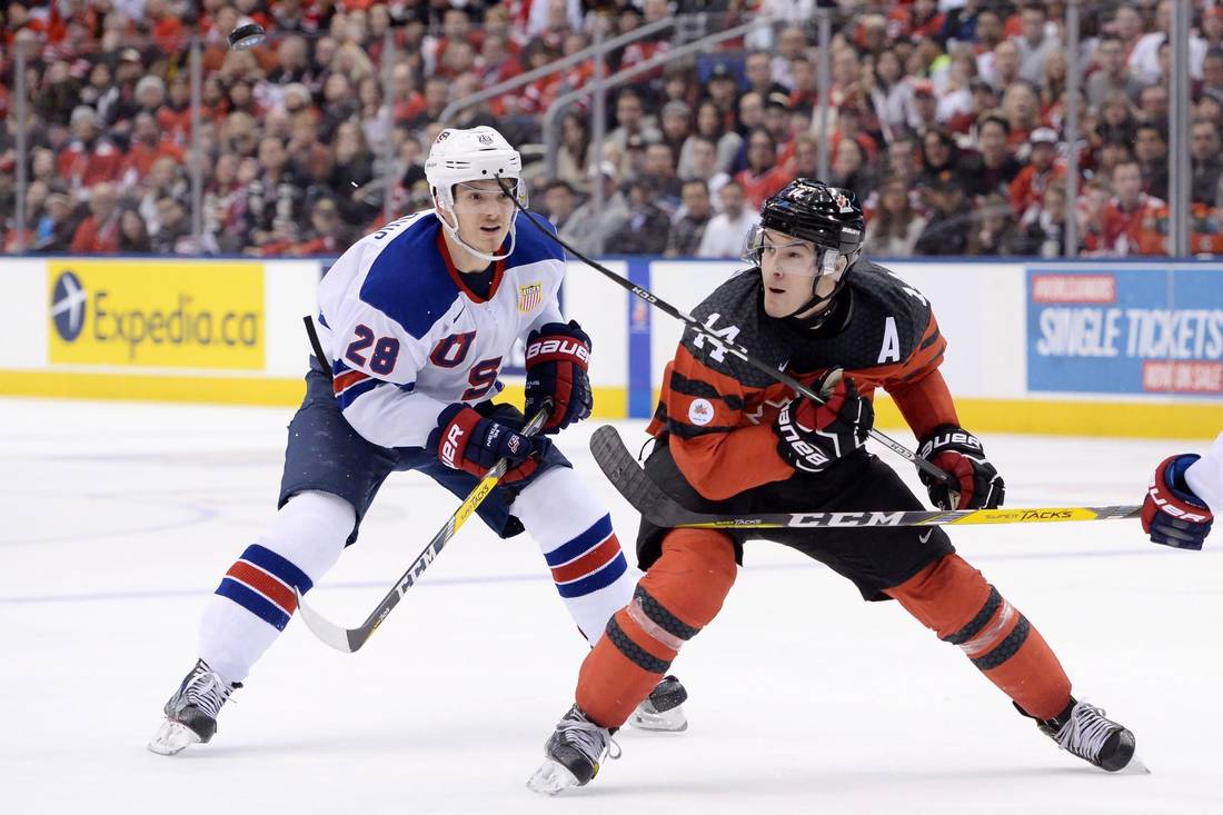 Canada forward Matt Barzal (14) keeps his eye on the puck as United States forward Jack Roslovic (28) defends during third period IIHF World Junior Championship hockey action in Toronto on Saturday, Dec. 31, 2016.