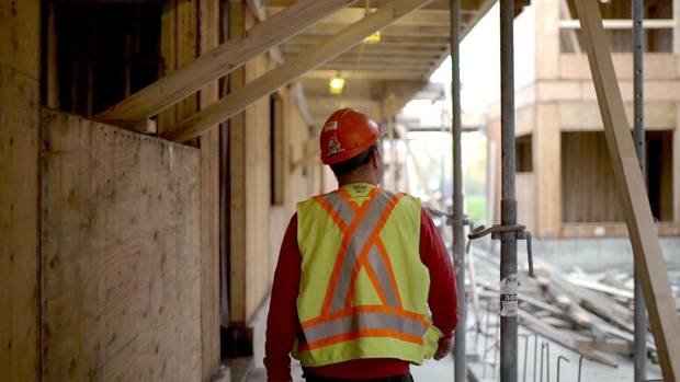 A worker walks through one of the Co-op Federation's projects under construction along the Fraser River.