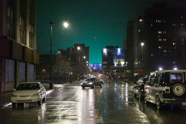 The colourful glow of Ford Field is seen in the distance, in downtown Detroit’s Cass Corridor.