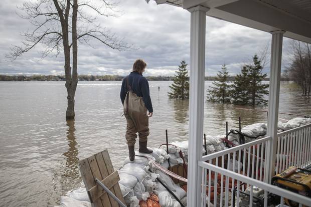 May 9: Patrice Pepin walks along a barrier of sandbags holding back the Ottawa River's waters at the home of his brother Christian Pepin and wife Marie-Pierre Chalifoux in Saint-Andre-d'Argenteuil, 90 kilometres west of Montreal.