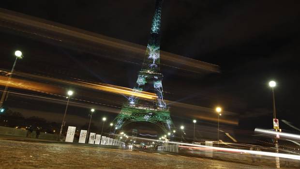 An artwork entitled One Heart One Tree by artist Naziha Mestaoui is displayed on the Eiffel Tower as part of the COP21 conference on Nov. 30, 2015.
